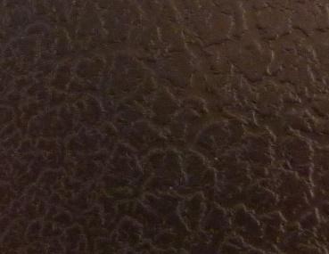 Crackle paint: aged leather effect with cracks. Black color, tone on tone application.